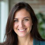 Elara Vance, Lead Travel Designer, smiling confidently.